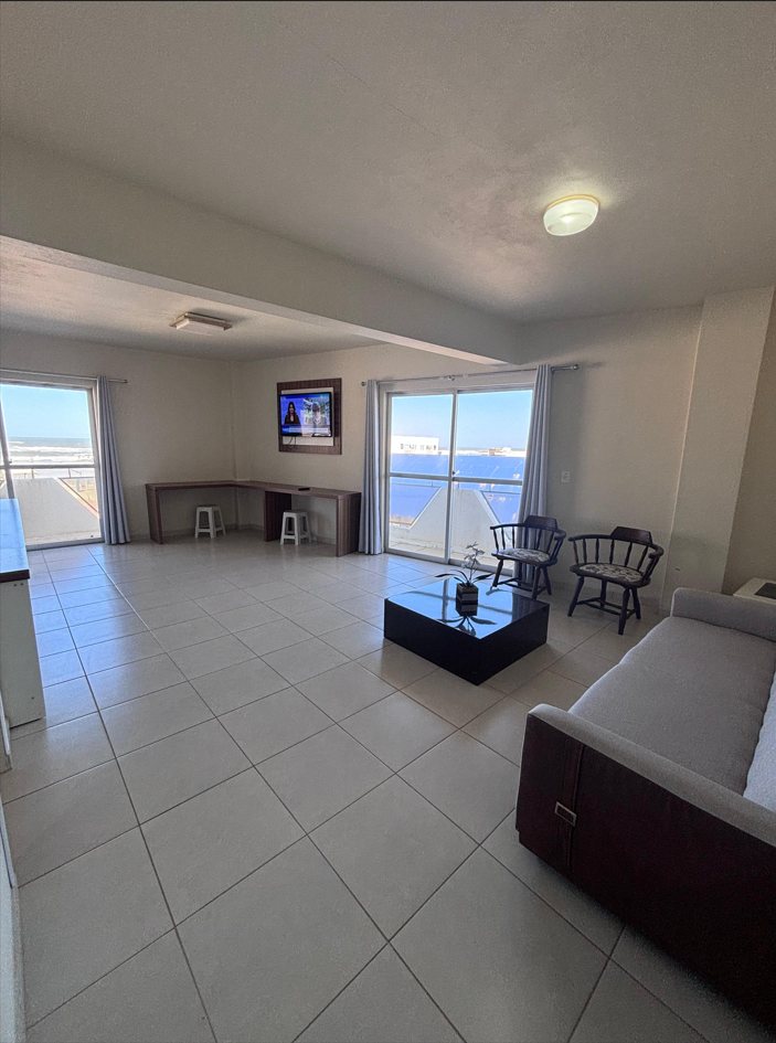 Suíte Panorâmica — sala com vista para o mar